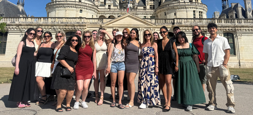 Students standing and smiling in France