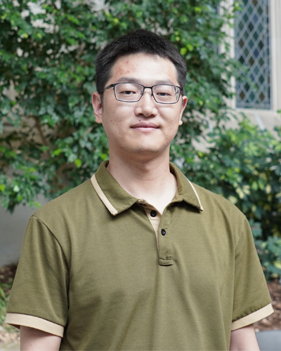 Bei facing the camera in a green shirt