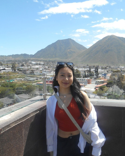Cecile smiling in front of mountains
