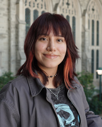 Photo of a female student with brunette and red hair smiling