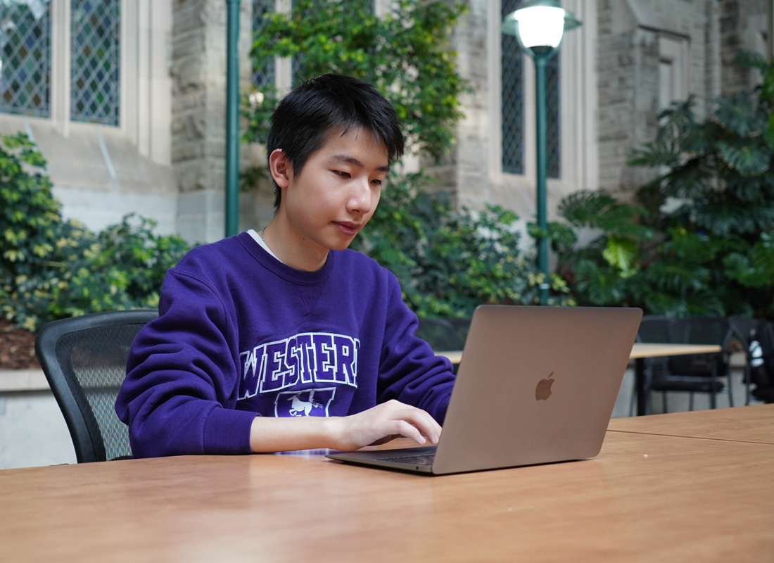 A student hard at work on a laptop