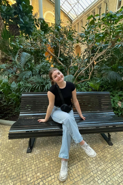 Kiara sitting on a bench and smiling