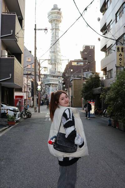 Zoe standing near Tsutenkaku in Osaka