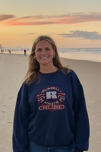 Halle smiling on a beach