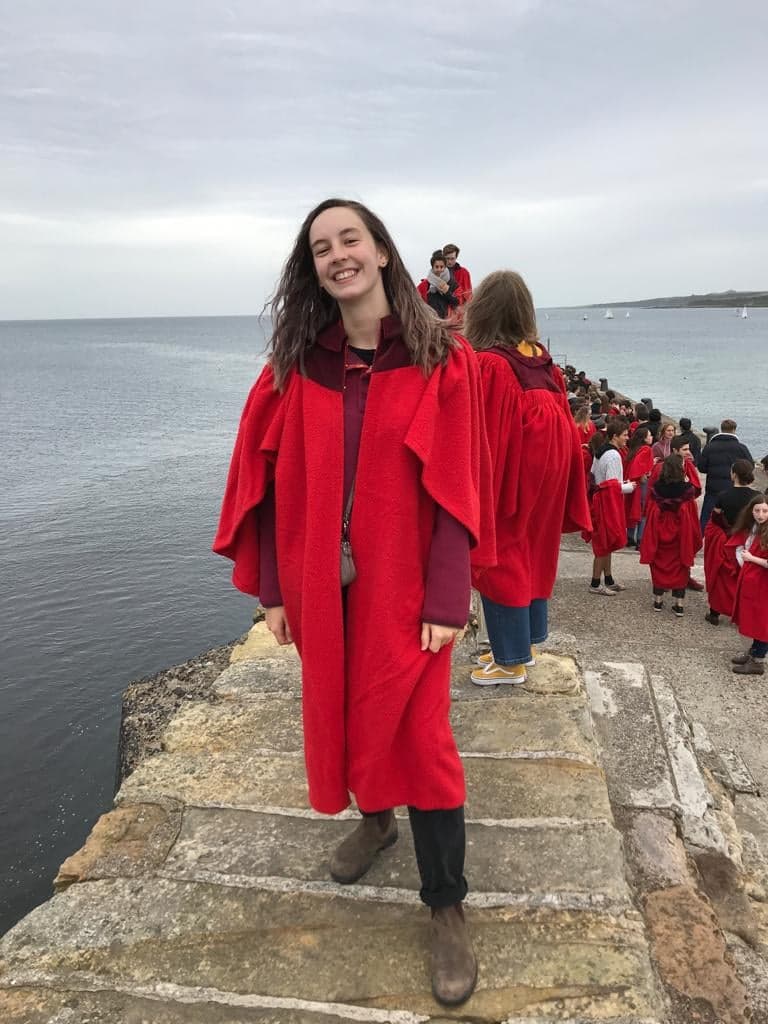 Emily in gown smiling on the pier
