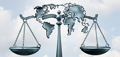 scales of justice with world map in between